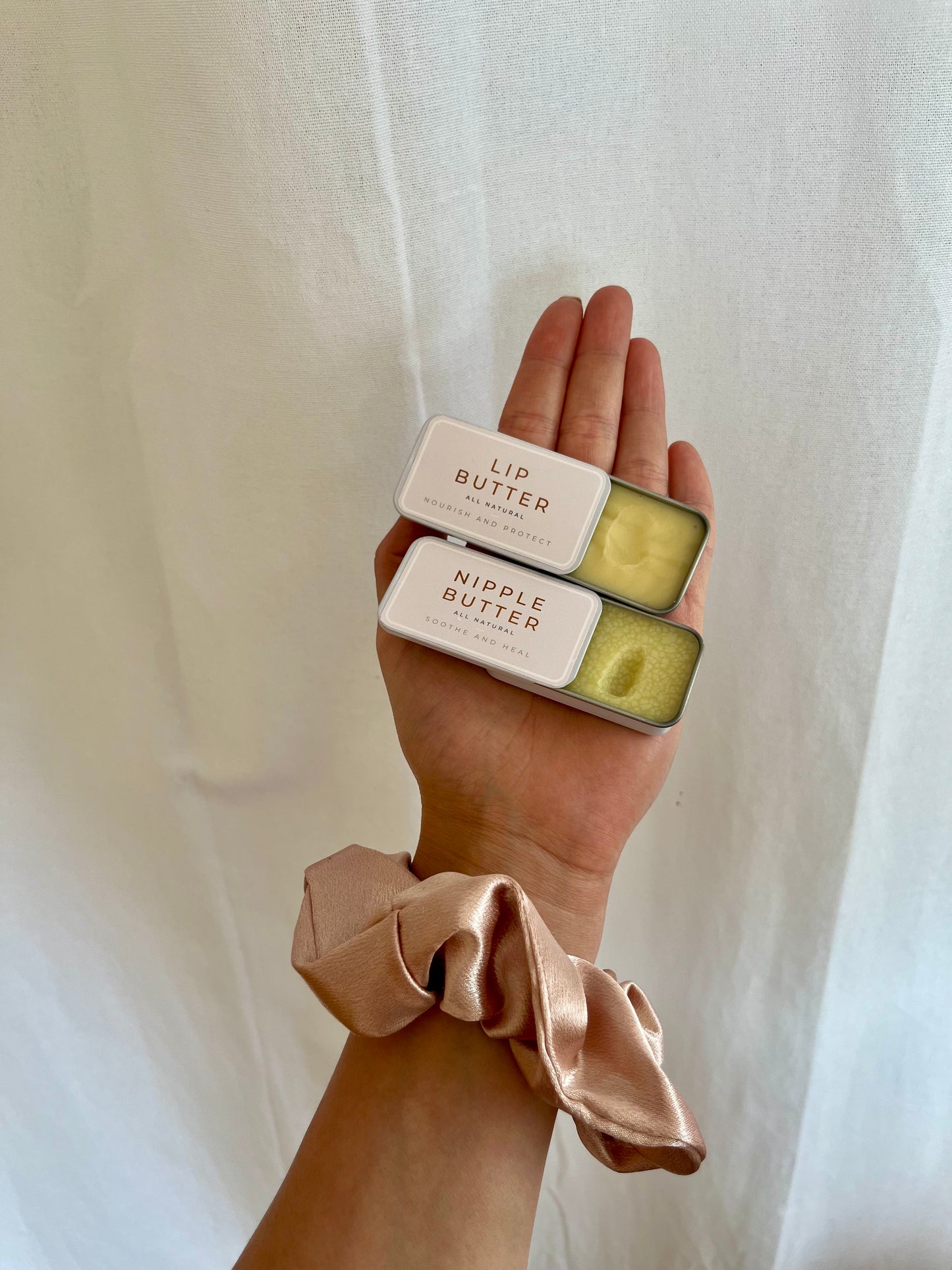 Natural lip butter tin held in hand