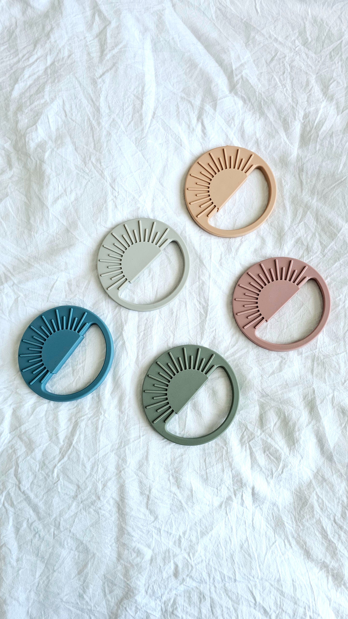 Sun silicone teether shown with colour range